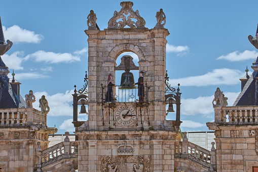 The Maragato Colas and Maragata Colasa chiming the clock on top of the town hall of Astorga, Spain