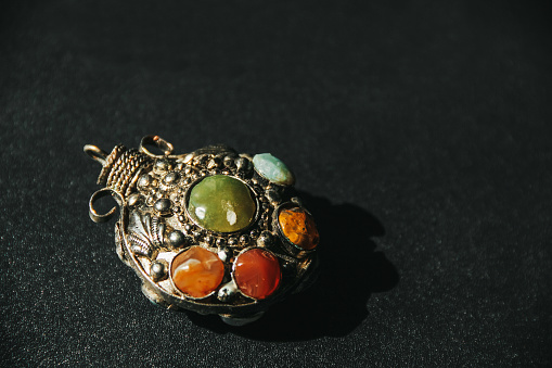 Beautiful pendant with large stones on a dark background