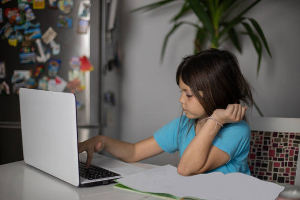 istock Little girl is studying at home and doing her homework. 1483125865