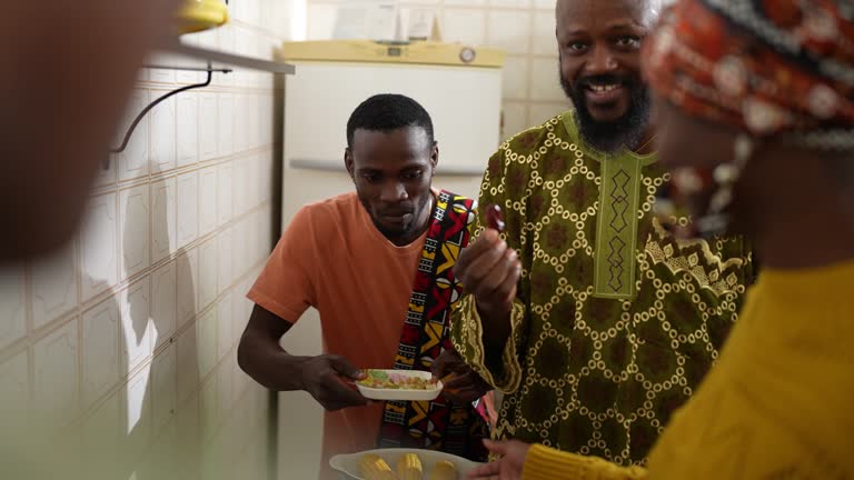 Family eating appetizer in the kitchen at home