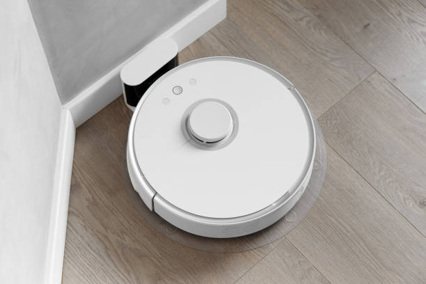 istock Robot vacuum cleaner connected to charging station 1483133236