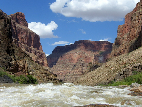 Lava Falls Rapid, looking upstream at Mile Marker 179 on Colorado River, Grand Canyon National Park. Rapid is Class 8-10 and has a 13-foot drop. Canyon walls contain lava flows from a now-extinct volcano.