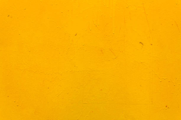 istock The metal surface is rough, with smudges, painted with yellow paint. Bright colored background. 1483136526
