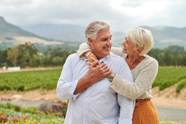 istock Mature woman smiling, hugging husband from behind in vineyard 1483138409
