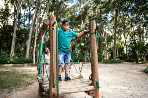 Disabled boy walking in the playground at the park