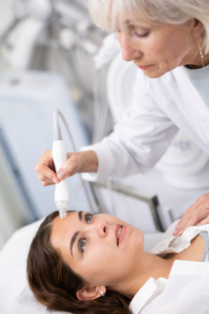 istock Young woman having face vacuum cleaning procedure 1483139507