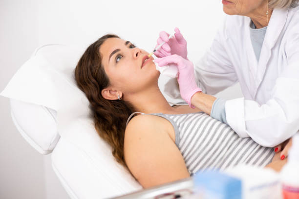 istock Young woman having mesotherapy procedure on her face performed by dermatologist 1483139572