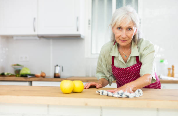 istock Mature woman cleaning kitchen table at home 1483141136