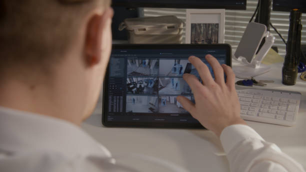 istock Security guard monitors CCTV cameras on tablet 1483141558