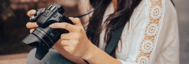 istock woman holding camera in street 1483142255