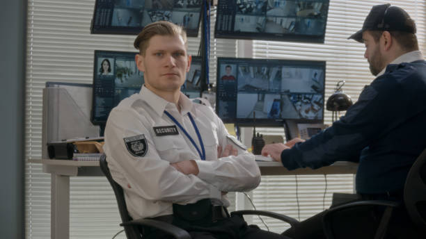 istock Security officer in observation room looks at camera 1483142271