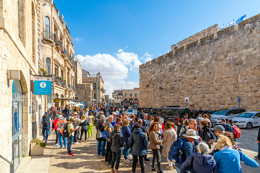 View towards the entrance to the winding streets of the ancient city from just inside the Jaffa Gate crowded with people, in Jerusalem Israel. Jaffa Gate is one of the seven main open gates of the Old City of Jerusalem.