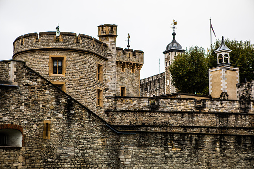 Tower of London with flag of England in London, Tower Hill, UK
