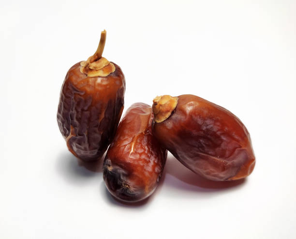istock Close up of dried dates fruit isolated on white background 1483143154