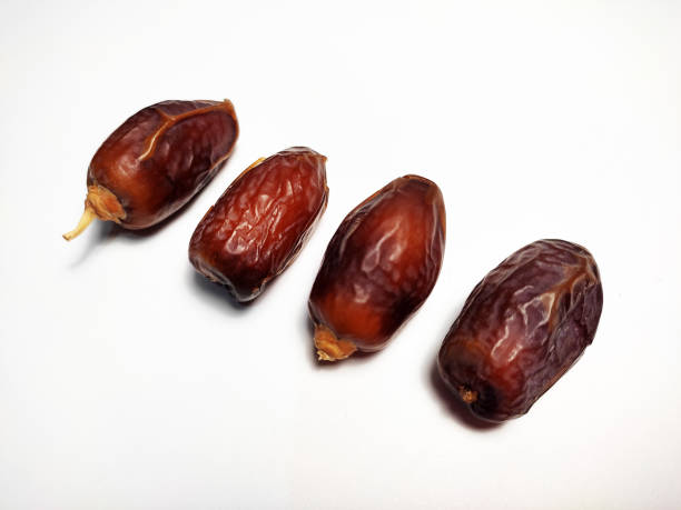 istock Close up of dried dates fruit isolated on white background 1483143371
