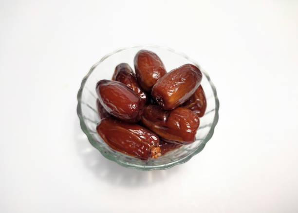istock pile of dates in transparent bowl, white background 1483143464