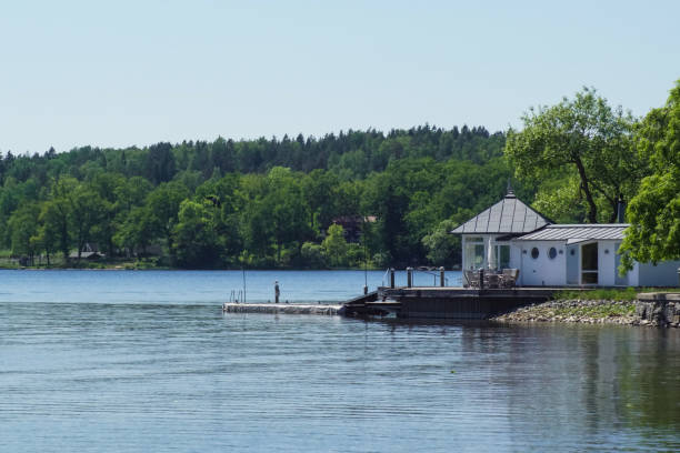 istock Building next to lake by trees against clear sky 1483145478