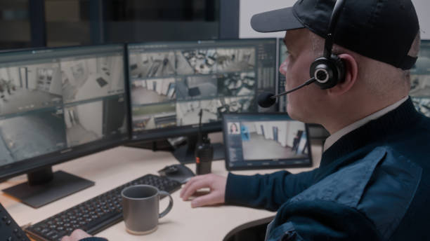 istock Security officer in headset controls CCTV cameras 1483145519