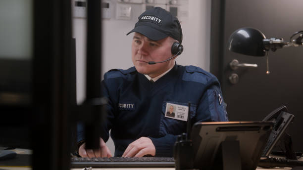 istock Busy security worker in headphones sits and typing keyboard 1483147291