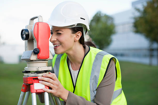 Engineer peering through theodolite  theodolite photos stock pictures, royalty-free photos & images