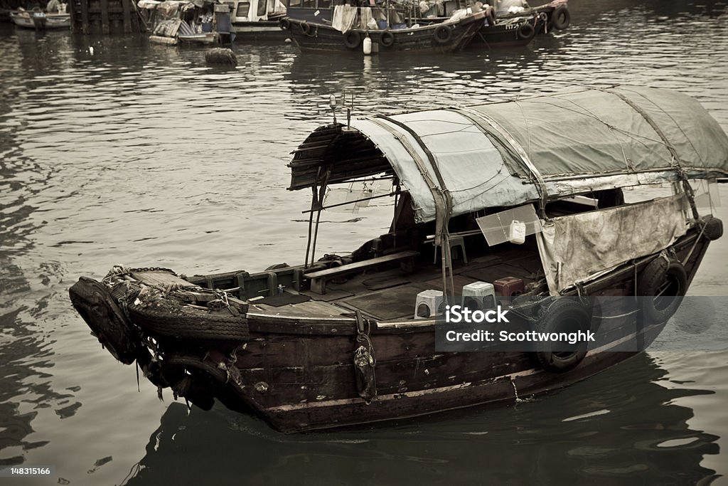 Sampan boat floating in the sea Sampan boat floating in the sea in Hong Kong Typhoon Shelter Sampan Stock Photo