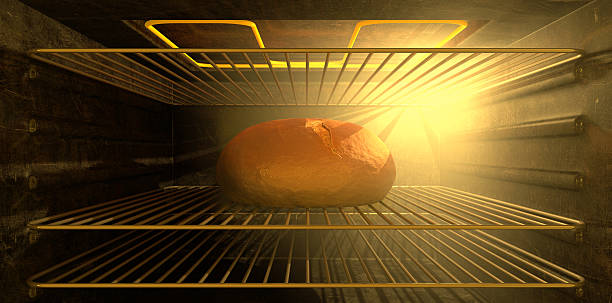 Loaf of bread cooking in the oven on the second rack