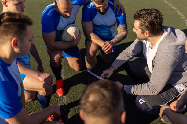 istock Rugby players talking tactics with coach 1483155397
