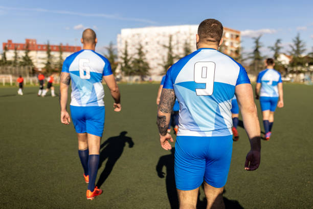 Group of men, male rugby team walking on the rugby field for a match together.
