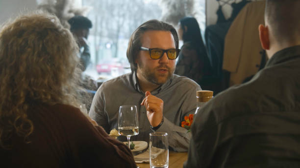 istock Man sits in modern gastro cafe with friends 1483157040