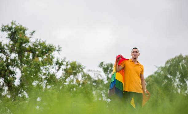 istock LGBTIQ+ community couples outdoors with the flag and sharing smiles. 1483157520