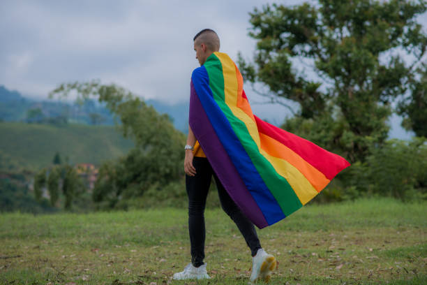 istock LGBTIQ+ community couples outdoors with the flag and sharing smiles. 1483158088