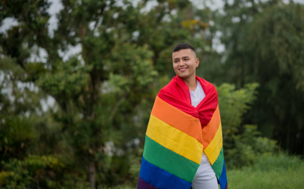 istock LGBTIQ+ community couples outdoors with the flag and sharing smiles. 1483158175