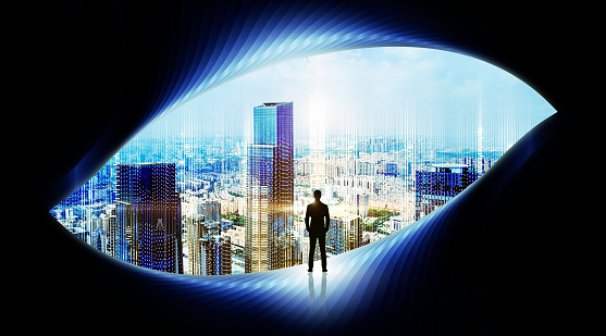 A Businessman looking at abstract tunnel with city in the background.