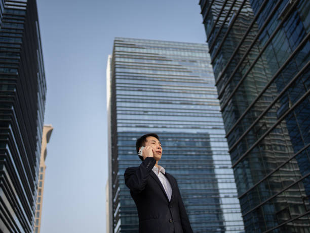 istock Employees using smartphones outside office building 1483161306