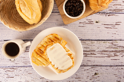 Delicious toasted bread with melted butter and cream cheese, Coffee, Brazilian breakfast