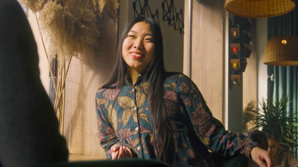 istock Asian woman sits in cafe and talks with man 1483164749