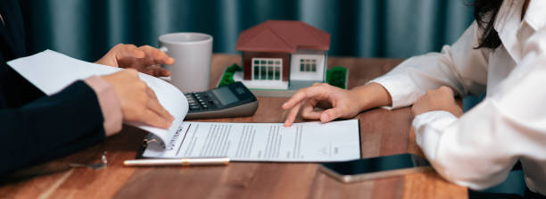 istock Reviewing house loan contract with agent using calculator. Enthusiastic 1483164986