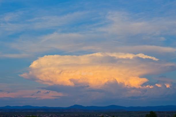 istock White and orange clouds in a blue sky over the desert, Arizona. 1483165687