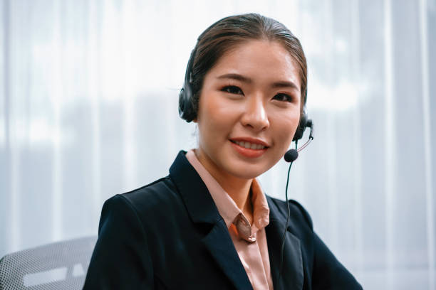istock Enthusiastic asian call center with headset on her workplace portrait. 1483166747