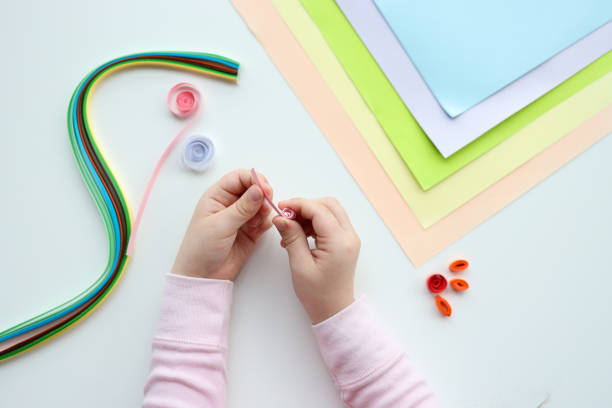 istock Children's activities, hands with paper top view, quilling technology 1483167183