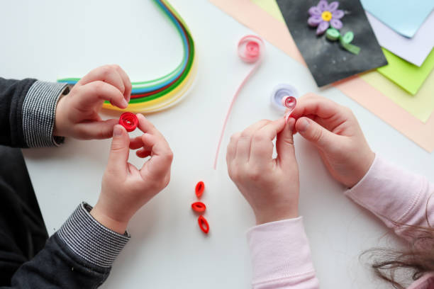 istock Children's activities, hands with paper top view, quilling technology 1483167184