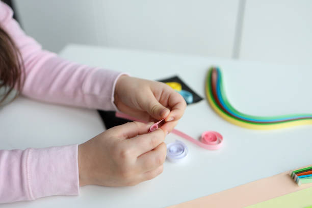 istock Children's activities, hands with paper top view, quilling technology 1483167186