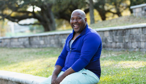 istock Plus size African-American man at park, smiling at camera 1483169934