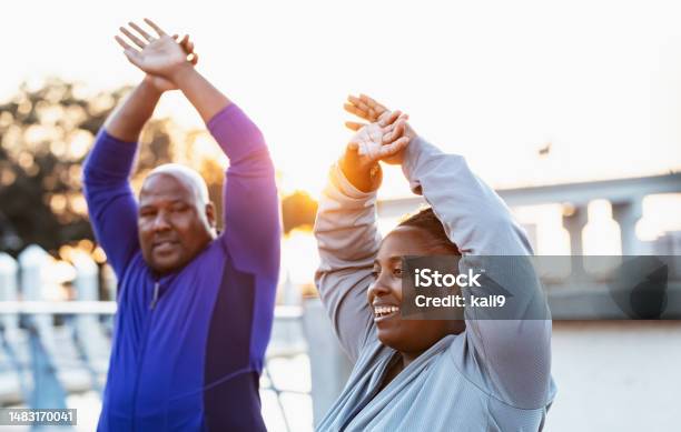 Mature Africanamerican Couple Stretching Focus On Woman Stock Photo - Download Image Now