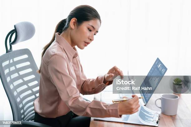 Young Asian Enthusiastic Businesswoman At Modern Office Desk With Laptop Stock Photo - Download Image Now