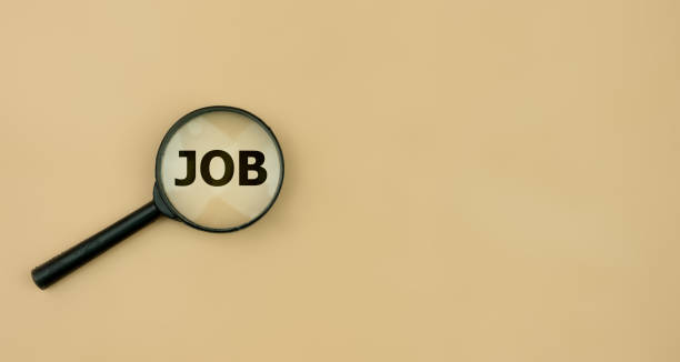 istock Black magnifying glass with JOB lettering on light yellow background. 1483171738