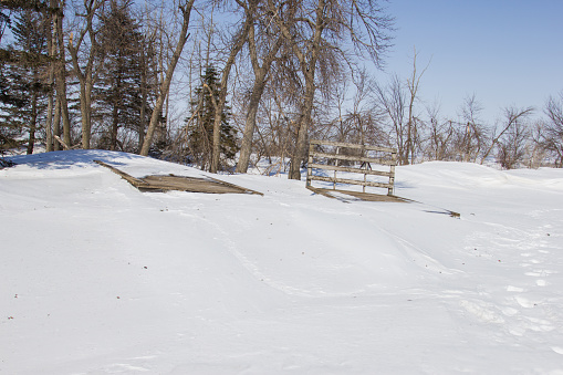 Hay racks buried in a snowdrift.