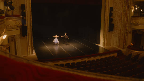 istock Ballet dancers practice choreography on theater stage 1483173899