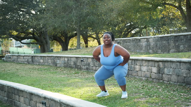 Mature African-American woman exercising, deep knee bends