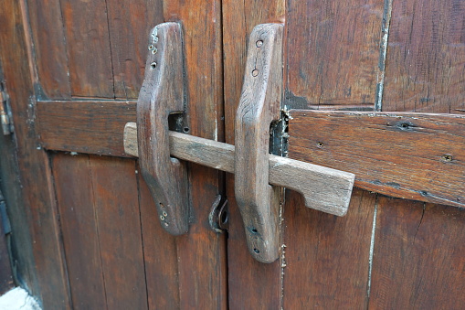 handmade wooden lock or ancient door latch. \nThailand traditional wood door